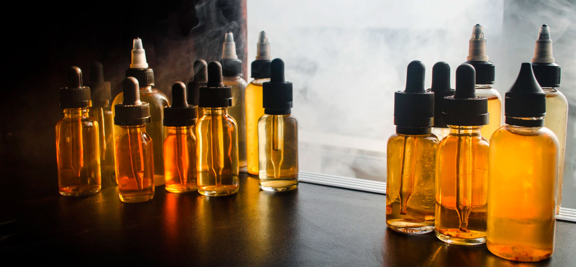 A lot of CBD Vape Juice bottles in smoke.