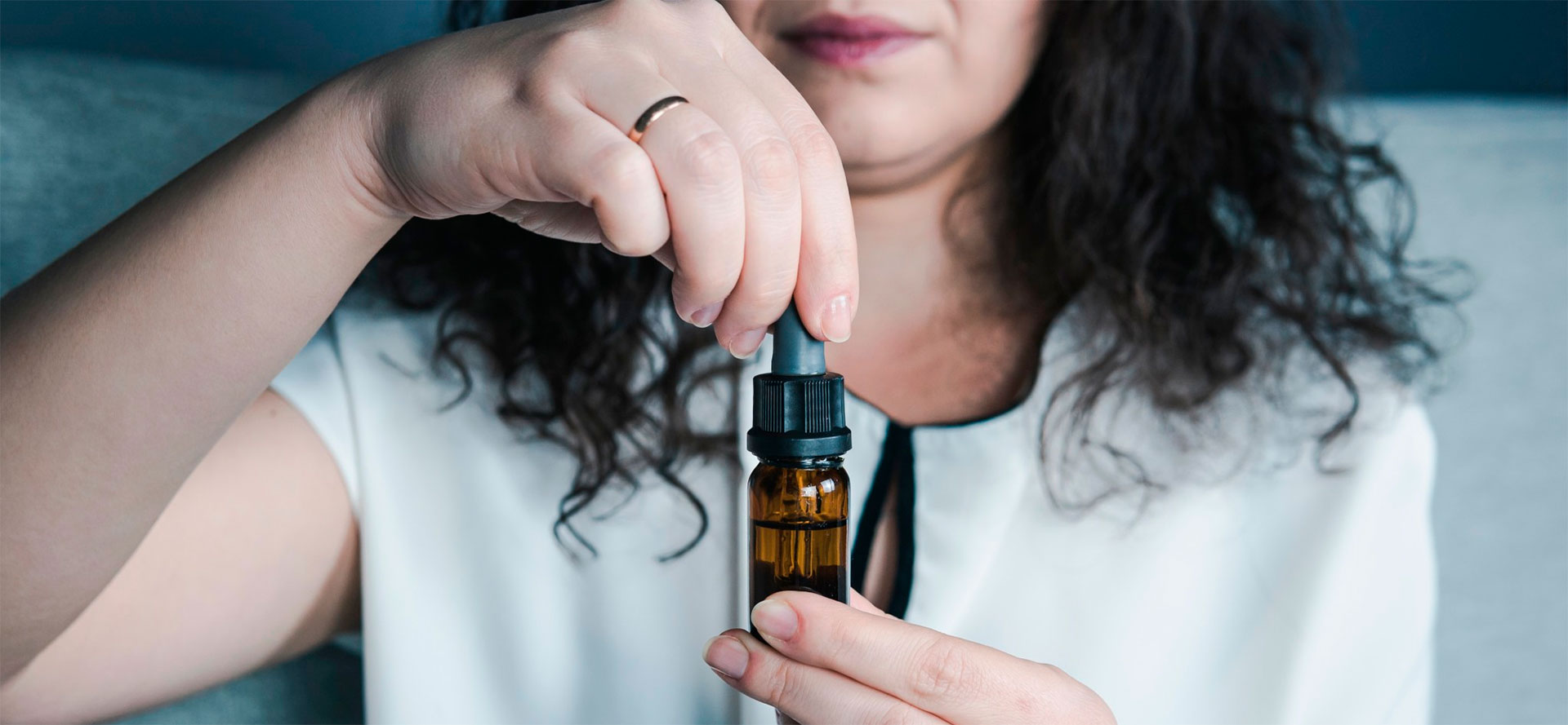 CBD Oil for Tourettes bottle in woman's hands.