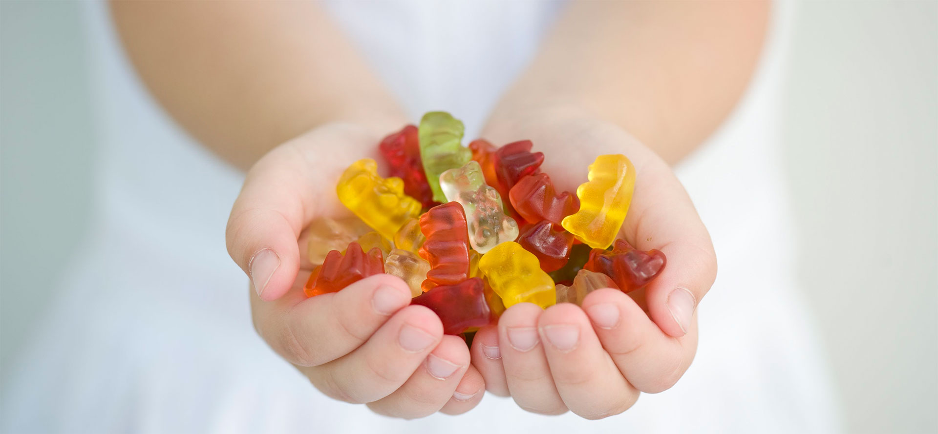 Kid with CBD gummies.