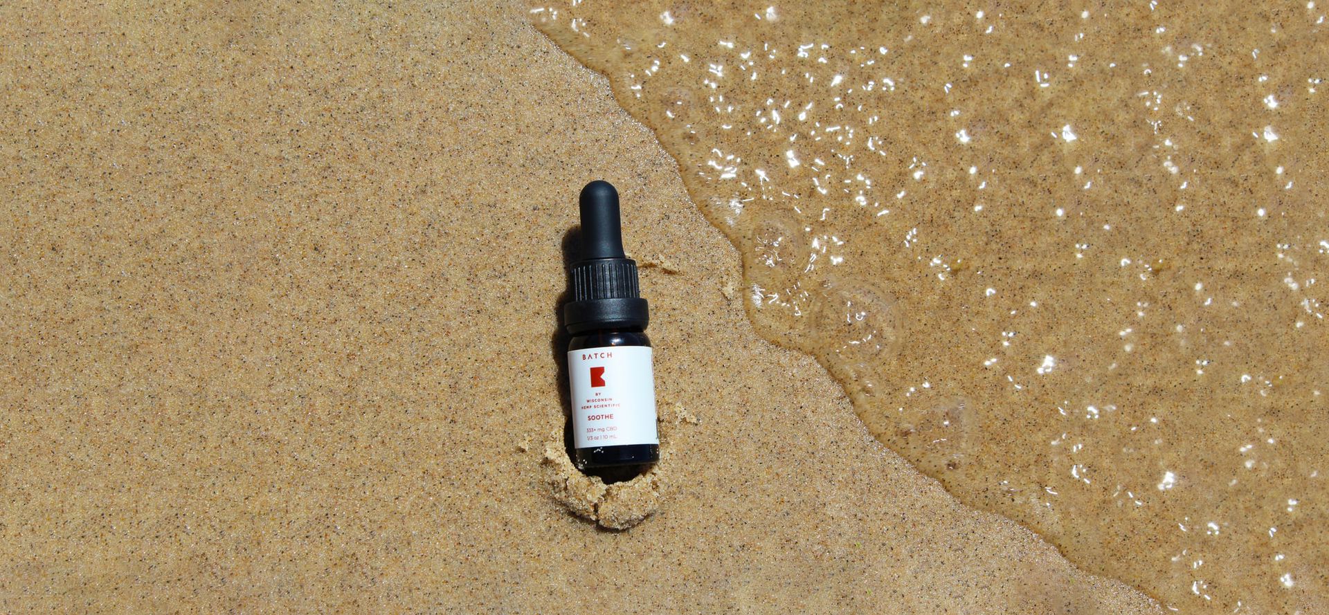 CBD Oil In The Sand.