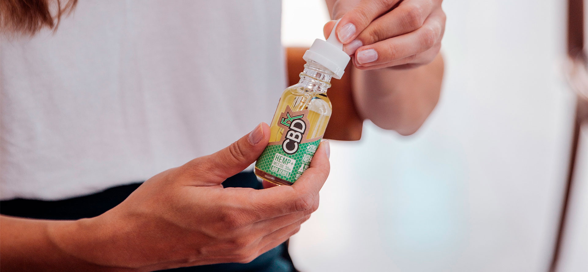 CBD bottle in hands for Parkinsons  treatment.